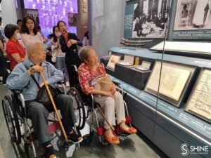Li Shifeng (a destra), la prima generazione di receptionist dell'ex sede del congresso, visita il memoriale con altri ex colleghi.